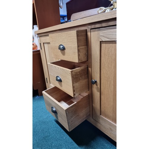 496 - Modern solid light oak sideboard with two doors and three drawers in excellent clean condition throu... 