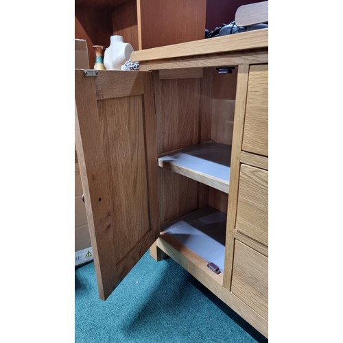 496 - Modern solid light oak sideboard with two doors and three drawers in excellent clean condition throu... 