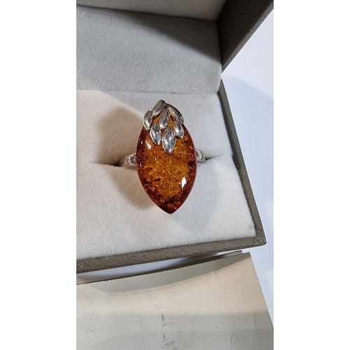 405 - Good quality 925 silver dress ring inset with a large oval genuine baltic amber stone with a COA fro... 