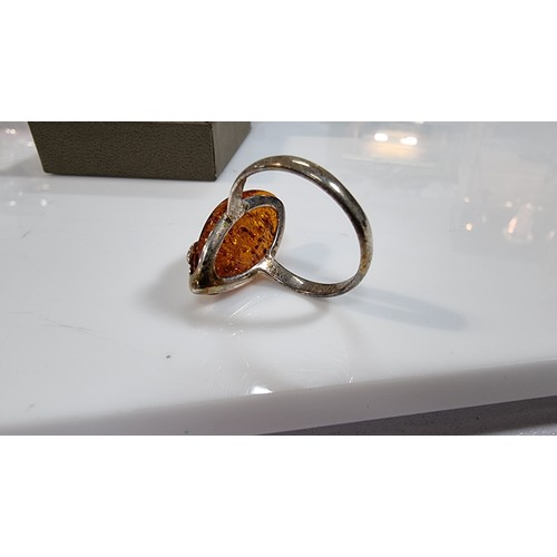 405 - Good quality 925 silver dress ring inset with a large oval genuine baltic amber stone with a COA fro... 