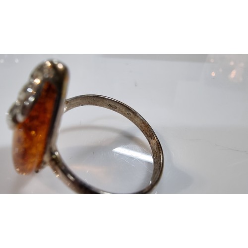 405 - Good quality 925 silver dress ring inset with a large oval genuine baltic amber stone with a COA fro... 