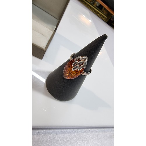 405 - Good quality 925 silver dress ring inset with a large oval genuine baltic amber stone with a COA fro... 