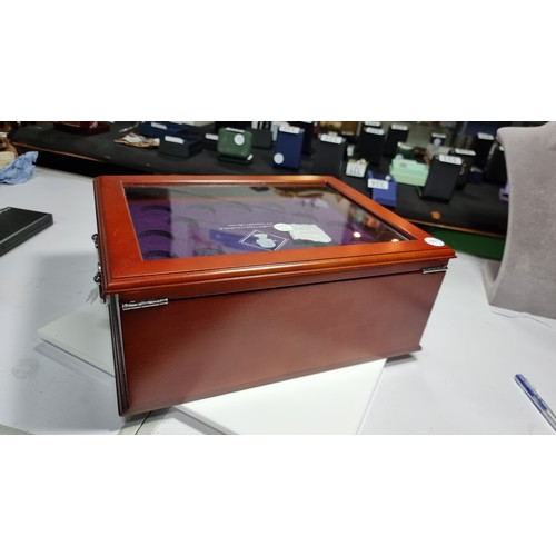 260 - Queen Elizabeth II wooden coin display case (empty) with a glazed top and four drawers to the base e... 