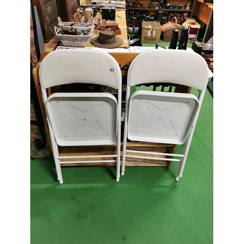 483 - 2x folding indoor/ outdoor white metal chairs with leatherette seat & back.