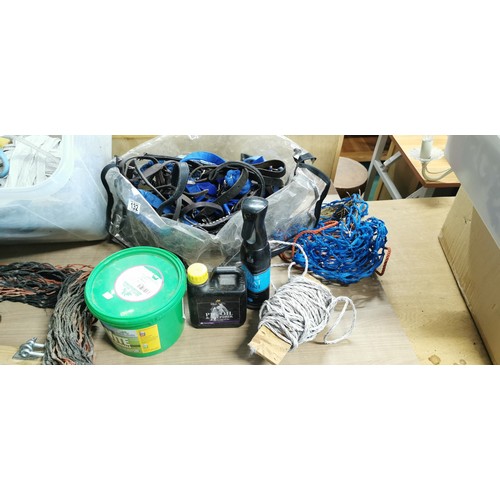 132 - Large box with electric fence tape, bridal parts,stirrup treads, reins,head collars, lead reins, hay... 