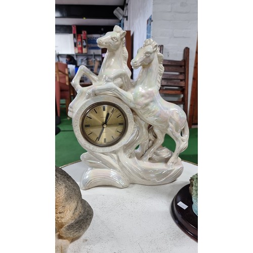 46 - Quantity of collectable china to include a large ceramic pearlescent horse formed quartz clock large... 