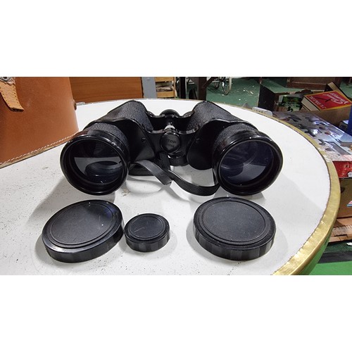 67 - Pair of elite 10 x 50 binoculars missing a eye piece protector and one lense cap