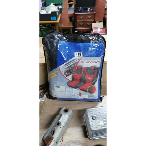 169 - Car seat cover set new in bag, extierior lamp fitting, tow hitch, a wood saw.