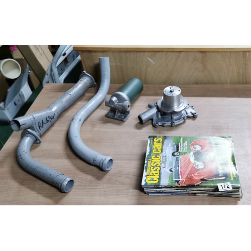 172 - Car parts including a new water pump and exhaust pipes and a fuel filter and some classic car mags, ... 