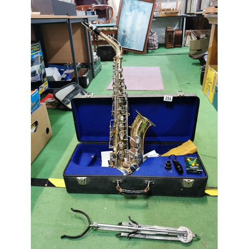 254 - A cased Pennsylvania brass saxophone, in good working order with large quantity of accessories inclu... 