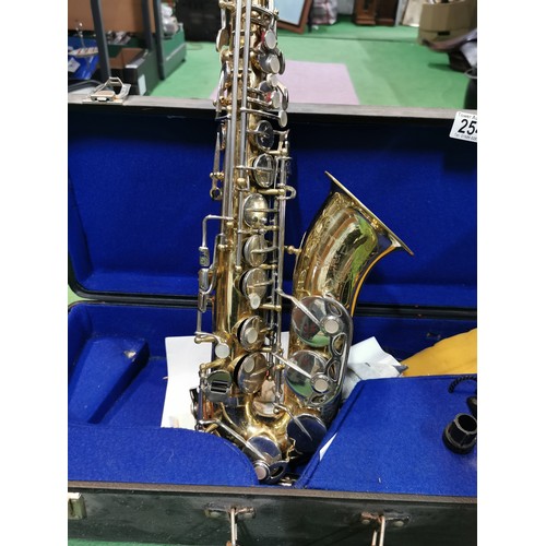 254 - A cased Pennsylvania brass saxophone, in good working order with large quantity of accessories inclu... 