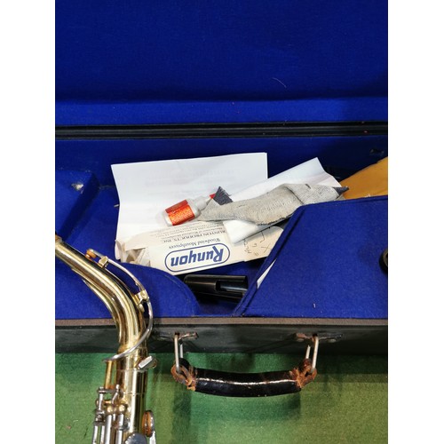 254 - A cased Pennsylvania brass saxophone, in good working order with large quantity of accessories inclu... 