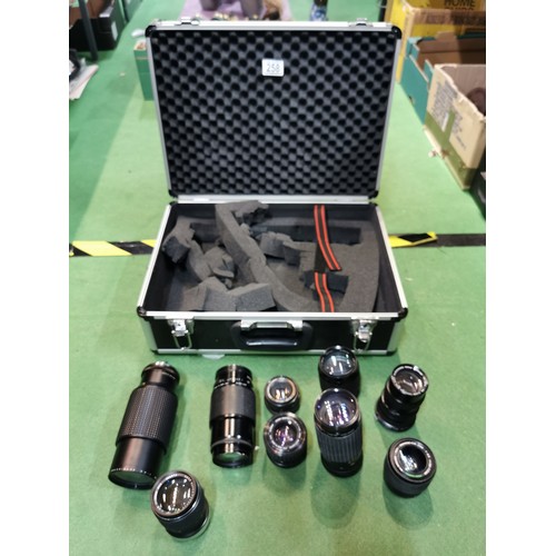 258 - A heavy duty fitted camera case with foam lining containing a quantity of lenses inc Vivitar 70-150m... 