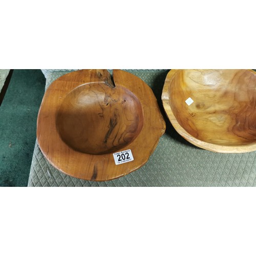 202 - 2x fruit wooden bowls in a good natural form. Measures 7.5cm height x width 30cm.