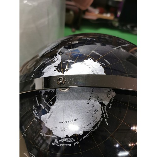 271 - An Ensco black and silver coloured terrestrial globe with time zones to the top rotating on twin axl... 