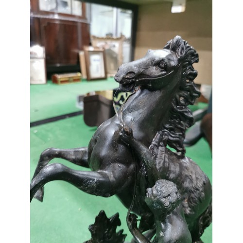 279 - A pair of spelter marley horses in overall good condition standing on wooden bases both are signed h... 