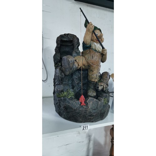 211 - Large fishing garden gnome with his dog rock water feature complete with power supply in good overal... 