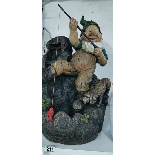 211 - Large fishing garden gnome with his dog rock water feature complete with power supply in good overal... 