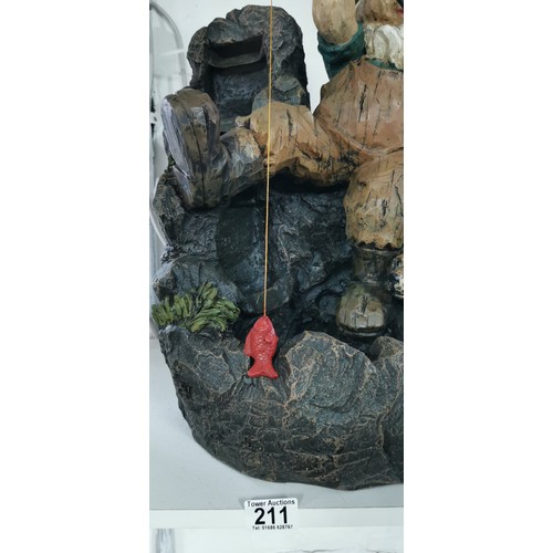 211 - Large fishing garden gnome with his dog rock water feature complete with power supply in good overal... 