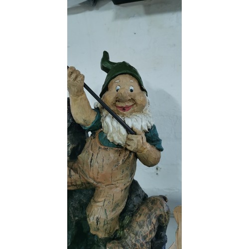 211 - Large fishing garden gnome with his dog rock water feature complete with power supply in good overal... 