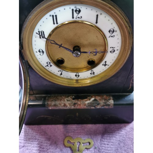 291 - An 8 day french slate clock with marble detail striking on a coiled gong, complete with pendulum and... 