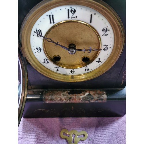 291 - An 8 day french slate clock with marble detail striking on a coiled gong, complete with pendulum and... 