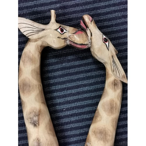 247 - Pair of tall wooden nuzzling giraffes, old repair to the head. Measures 80cm height x 28cm long x 8c... 