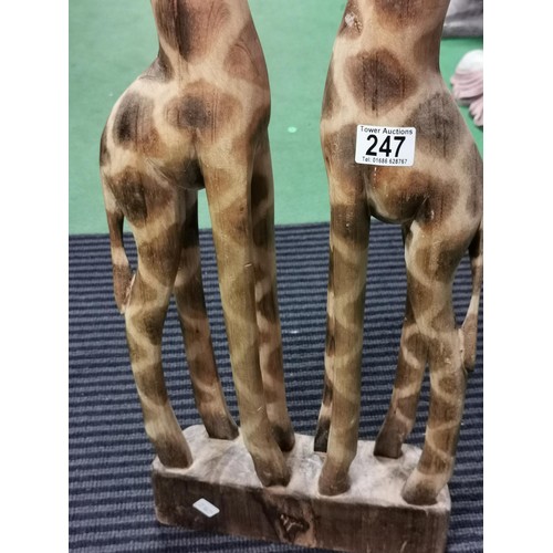 247 - Pair of tall wooden nuzzling giraffes, old repair to the head. Measures 80cm height x 28cm long x 8c... 