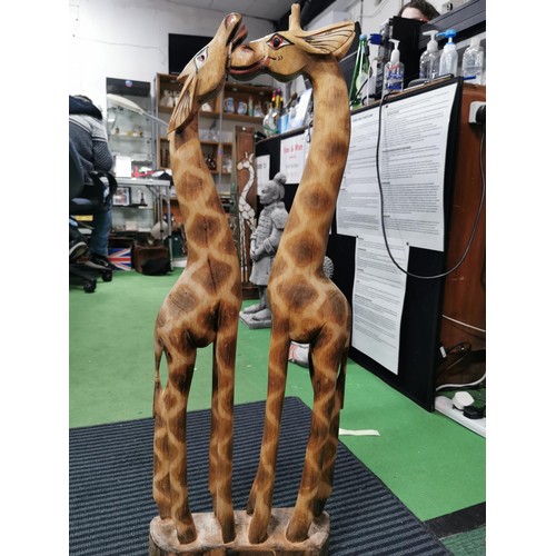 247 - Pair of tall wooden nuzzling giraffes, old repair to the head. Measures 80cm height x 28cm long x 8c... 