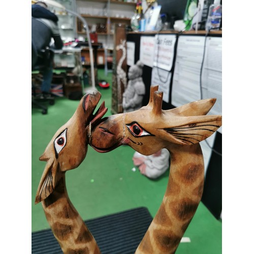 247 - Pair of tall wooden nuzzling giraffes, old repair to the head. Measures 80cm height x 28cm long x 8c... 