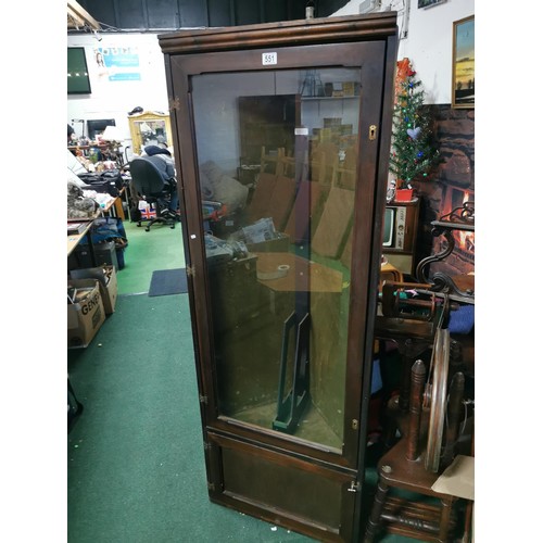 551 - Tall, glazed corner gun display cabinet with green felt interior and metal gun mounting and cupboard... 