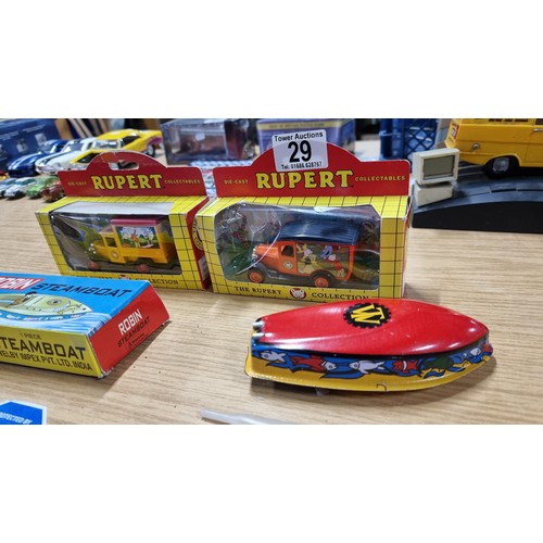 29 - 2x Diecast Rupert the Bear vehicles boxed along with a vintage boxed Robin tin steamboat in good con... 