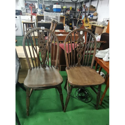 582 - A pair of farmhouse wheelback dining chairs in good overall condition.
Height 89cm Width 38cm Depth ... 