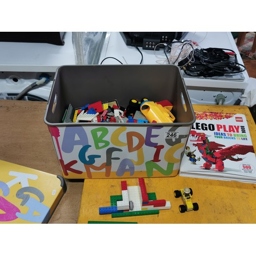 246 - A plastic lidded children's tub, containing a large quantity of Lego and a Lego play book.