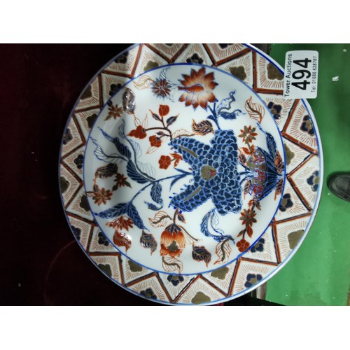 494 - A pair of Oriental plates, larger plate is hand decorated with oriental marks at the base, floral de... 