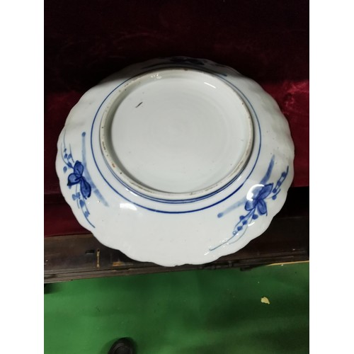 494 - A pair of Oriental plates, larger plate is hand decorated with oriental marks at the base, floral de... 