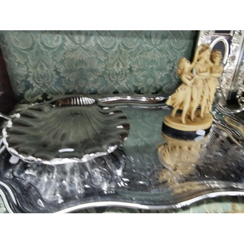 497 - A quantity of plated ware including a plated butlers tray, two large scalloped form dishes, a set of... 