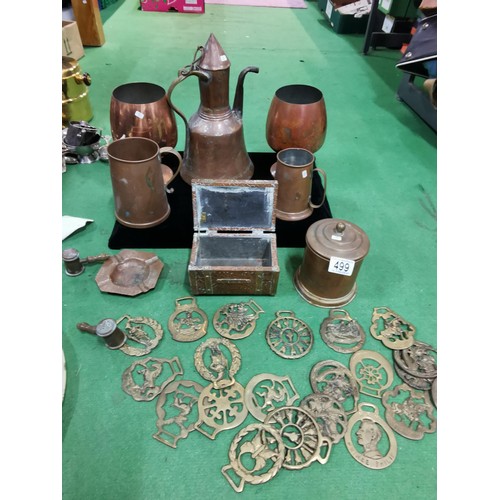 499 - A quantity of brass and copper items including two large copper goblets a quantity of horse brasses ... 