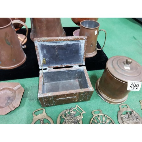 499 - A quantity of brass and copper items including two large copper goblets a quantity of horse brasses ... 