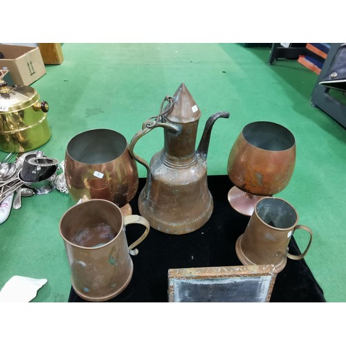 499 - A quantity of brass and copper items including two large copper goblets a quantity of horse brasses ... 