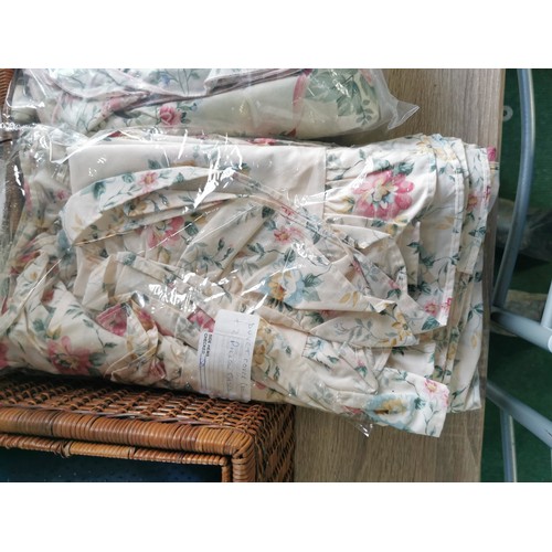 264 - A wicker picnic basket along with a wicker tray. Containing two double duvet cover and pillow cases,... 