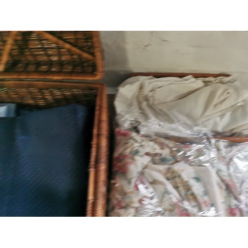 264 - A wicker picnic basket along with a wicker tray. Containing two double duvet cover and pillow cases,... 
