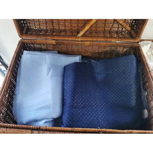 264 - A wicker picnic basket along with a wicker tray. Containing two double duvet cover and pillow cases,... 