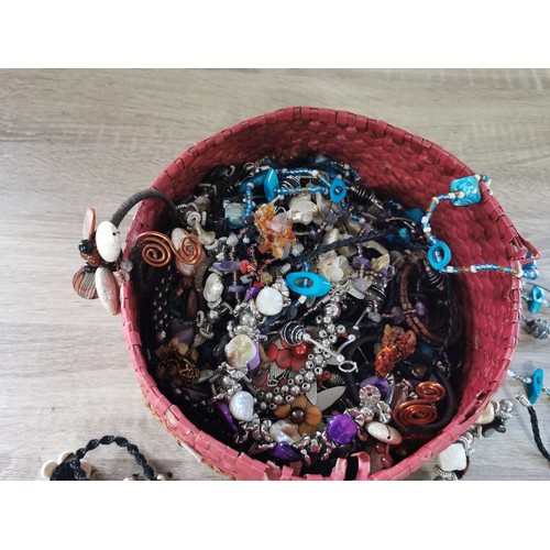 269 - A small hand made basket containing a large quantity of costume jewellery, including necklaces and b... 
