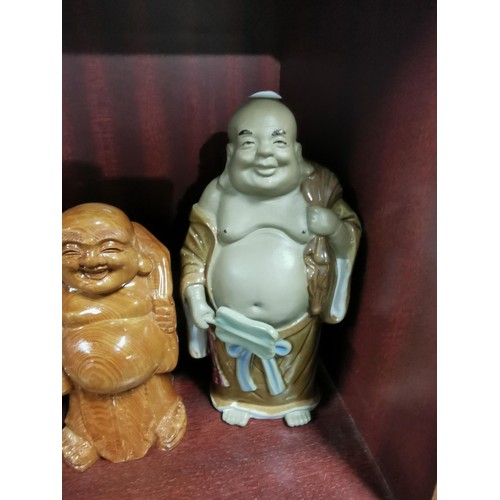 513 - A quantity of Buddhas of varying sizes including a tealight Buddha, a jade Buddha on stand, resins B... 
