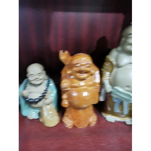 513 - A quantity of Buddhas of varying sizes including a tealight Buddha, a jade Buddha on stand, resins B... 