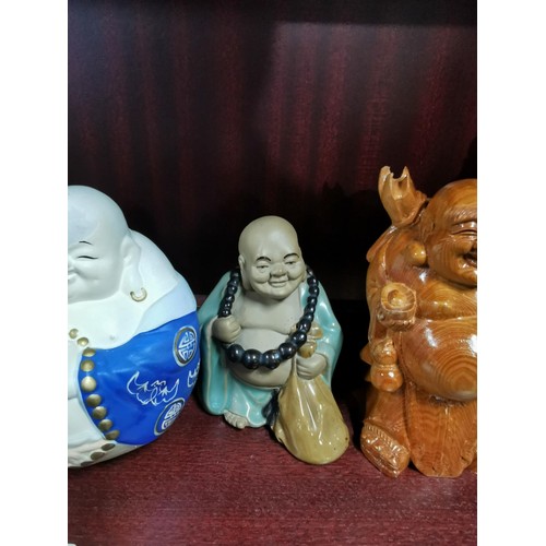 513 - A quantity of Buddhas of varying sizes including a tealight Buddha, a jade Buddha on stand, resins B... 
