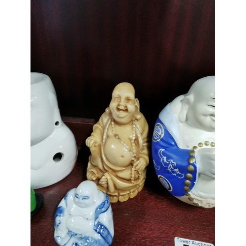 513 - A quantity of Buddhas of varying sizes including a tealight Buddha, a jade Buddha on stand, resins B... 
