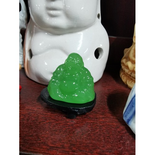 513 - A quantity of Buddhas of varying sizes including a tealight Buddha, a jade Buddha on stand, resins B... 