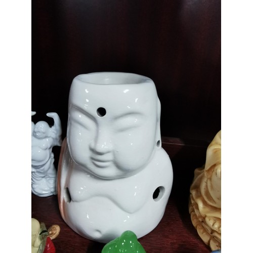 513 - A quantity of Buddhas of varying sizes including a tealight Buddha, a jade Buddha on stand, resins B... 